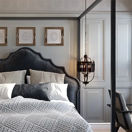 Bedroom with black tufted headboard and lantern
